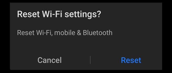 A closeup of an Android warning box asking “Reset Wi-Fi settings?” It continues “Reset Wi-Fi, mobile & Bluetooth” then gives the option to press either Cancel or Reset.